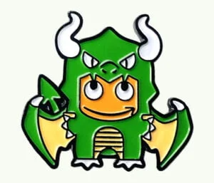 Custom soft enamel lapel pin featuring a cute cartoon character wearing a green dragon costume with white horns and wings.