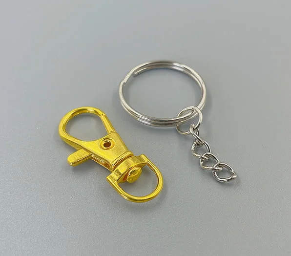 Key chain attachments featuring a gold-toned lobster clasp and a silver-toned split ring with a short chain.