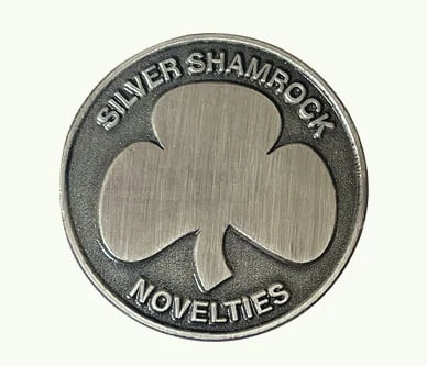 Custom die struck lapel pin with an antique silver finish featuring a central clover design and raised lettering for Silver Shamrock Novelties.