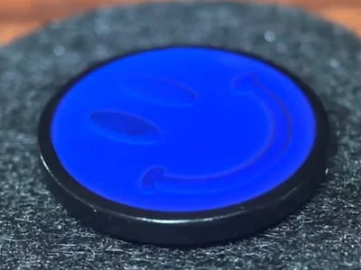 Custom blue thermochromic smiley face mood pin with temperature-sensitive color change