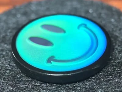 Custom cyan thermochromic smiley face mood pin with temperature-sensitive color change