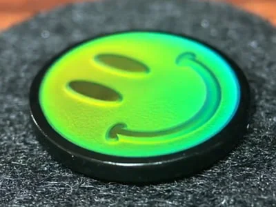 Custom lime green thermochromic smiley face mood pin with temperature-sensitive color change
