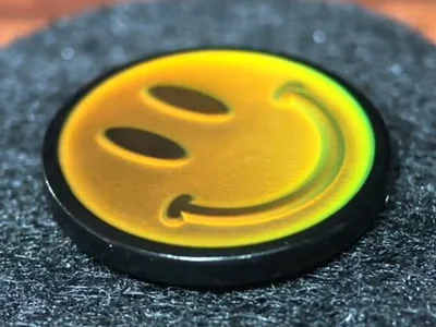 Custom yellow thermochromic smiley face mood pin with temperature-sensitive color change