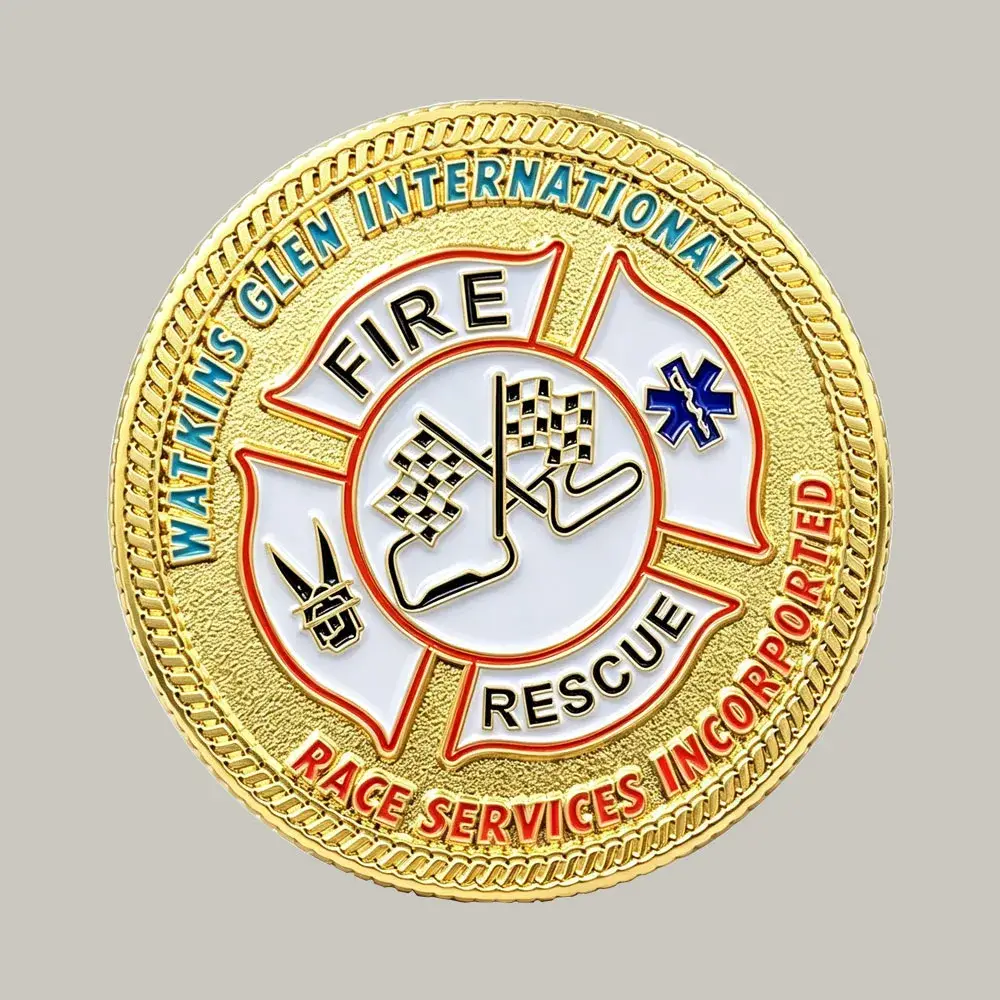 A custom gold challenge coin featuring the Watkins Glen International Fire Rescue Maltese Cross logo with checkered racing flags, Star of Life, and a rope edge border.