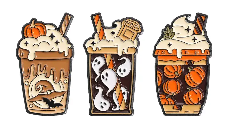 A set of three cute Halloween coffee cup soft enamel pins featuring pumpkins, ghosts, and witch hat designs.