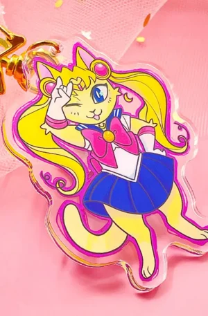 Custom anime cat acrylic keychain dressed as a magical sailor character with a gold star snap hook on a pink background.