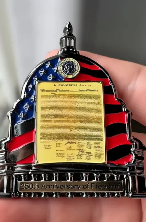 Custom challenge coin shaped like the US Capitol dome with an American flag enamel design, featuring a central Declaration of Independence plaque and a "250th Anniversary of Freedom" base.