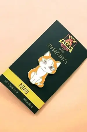 Custom Enamel Pin - Orange and White Sitting Cat Lapel Pin Displayed on Custom Backing Card by Plush Art Club Featuring Ilya Kuvshinov's "Potato" Art