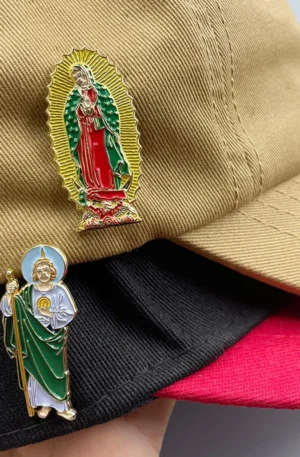 Custom Enamel Hat Pins - Our Lady of Guadalupe and Saint Jude Religious Lapel Pins Displayed on Layered Baseball Caps