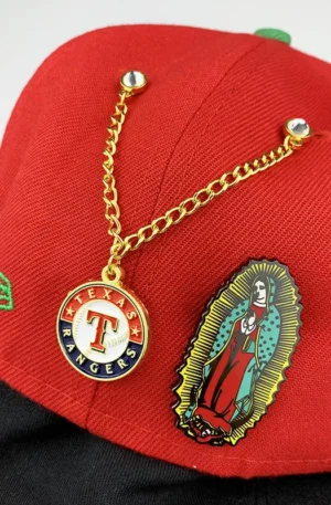 Custom Enamel Hat Pins - Texas Rangers Logo Double Rhinestone Chain Lapel Pin and Our Lady of Guadalupe Pin Displayed on a Red Baseball Cap