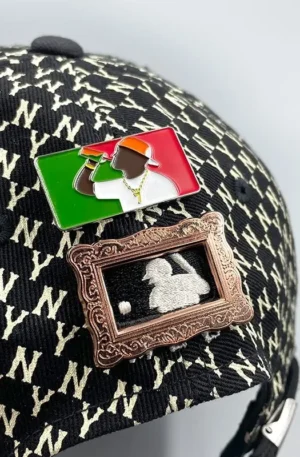 Custom Enamel Hat Pin - Rectangular Red-White-Green Logo Pin and Vintage Bronze Framed Baseball Batter Pin Displayed on a Black Monogram Baseball Cap