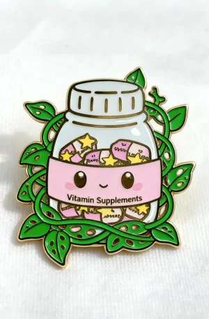 Custom enamel pin featuring a cute vitamin supplements bottle with a smiling face, pink capsules, stars, and green trailing leaves with gold plating