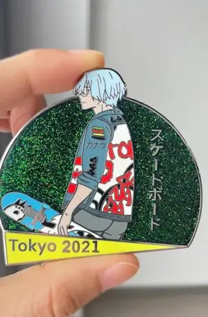 Custom enamel pin featuring an anime skateboarder profile against a dark green glitter background with Japanese text, a skateboard, and a "Tokyo 2021" yellow banner with gold plating