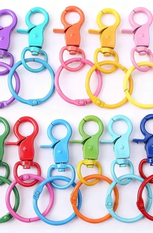 Assorted colorful metal lobster clasps and round split keyrings in a wide variety of bright finishes including purple, turquoise, orange, yellow, pink, green, red, and blue for custom keychains and hardware supplies.