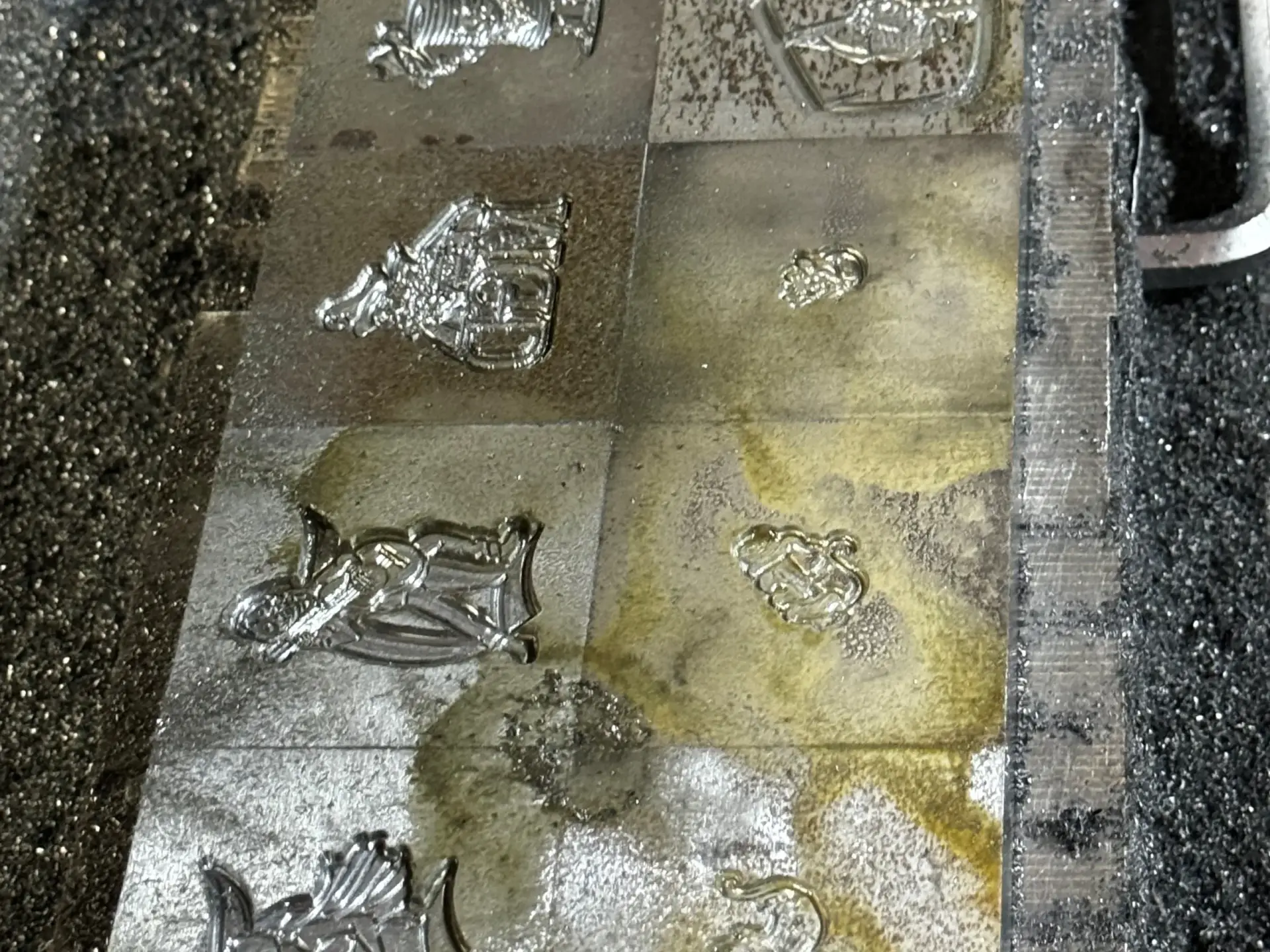 Finished metal molds produced via CNC Die Engraving for custom enamel pins.