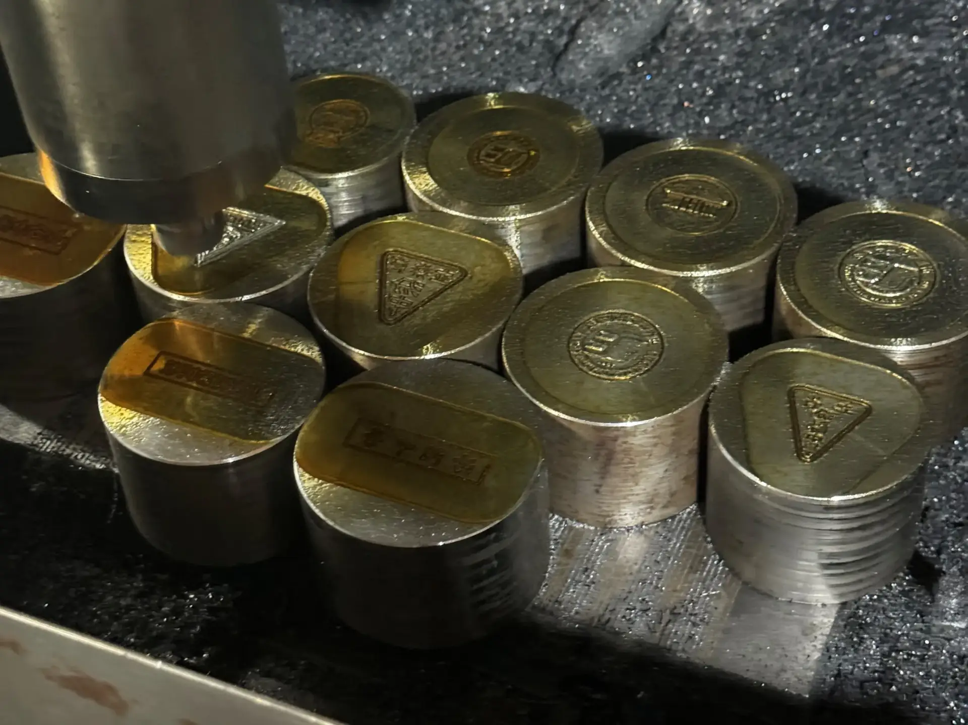 High-precision CNC Die Engraving machine carving custom metal molds for pins and badges.